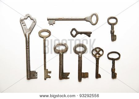 Many Old Keys To The Safe On A White Background