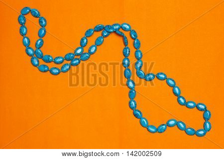 Beads With Natural Stone Turquoise Closeup On Orange Background