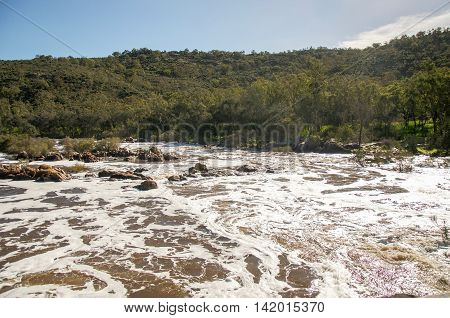 Lush peaceful landscape surrounding the white waters of the Bell Rapids in the Swan Valley in Western Australia.