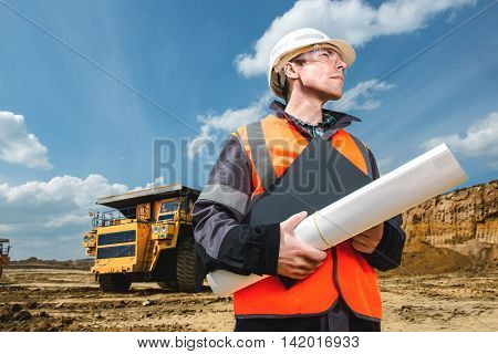 engineer with documents. male worker at an open pit