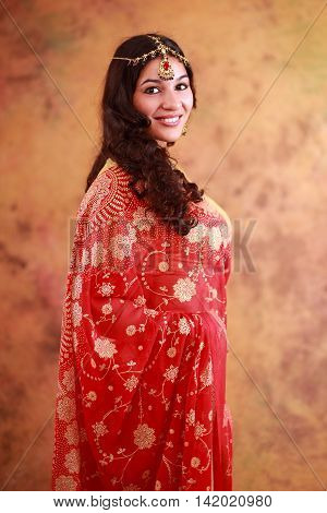 Indian girl in traditional dress on an abstract yellow background