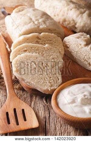 Sliced Boiled Knedle Close-up And Sour Cream. Vertical