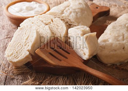 Fresh Sliced Yeast Knedliks And Sour Cream Close-up. Horizontal