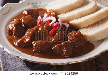 A Thick Stew With Boiled Dumplings On A Plate Close-up. Horizontal
