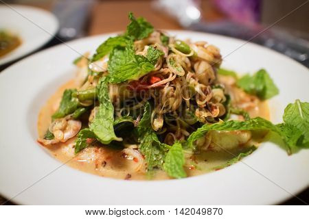 Thai foods "Pla Koong" (Spicy Shrimp Salad) Grilled shrimps with onionsmint leafcilantro and spicy lime sauce on top of green salad
