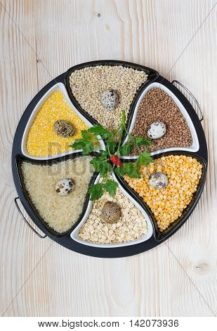 different cereals gathered in a circle, on a white board