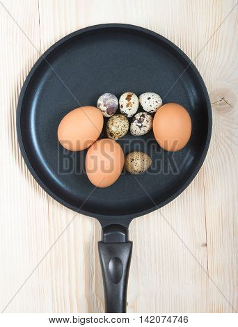 quail and chicken eggs in a frying pan