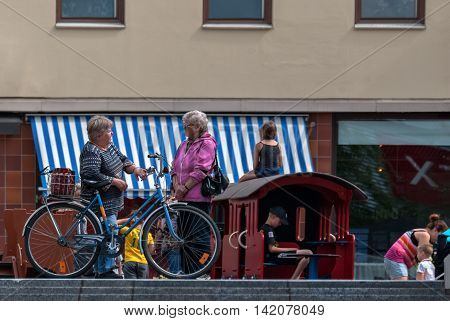 IMATRA FINLAND June 24: A leisurely conversation between two elderly women on the main street of the Finnish town of Imatra 24 June 2016.