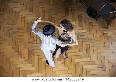 High Angle View Of Dancers Performing On Wooden Floor