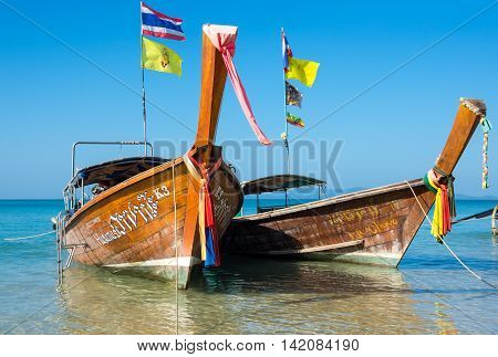 CRABI PROVINCE THAILAND - FEBRUARY 04 2015: Traditional thai long tail boats waiting for tourists to travel to beautiful islands in Thailand