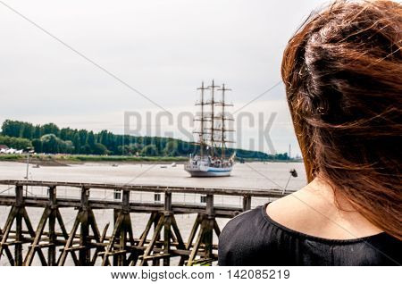 girl sees ship moving away further and further