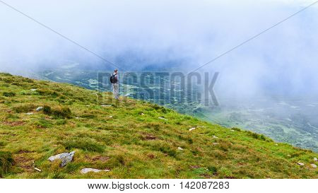 Tourist looking at the landscape on the top of Hoverla mount Carpathians