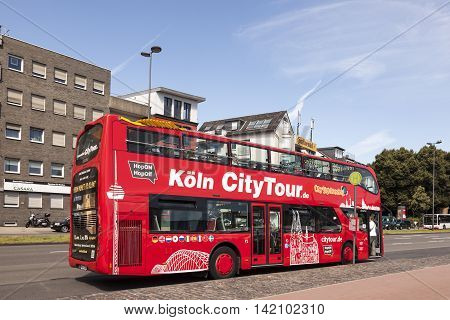 COLOGNE GERMANY - AUG 7 2016: Red sightseeing bus in the city of Cologne. North Rhine-Westphalia Germany