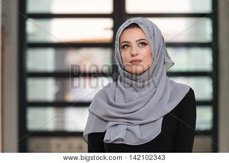 Young Caucasian Woman Praying With Head Dress