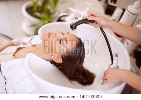Portrait of women which wash hair in a beauty salon.Hairdresser washing hair.