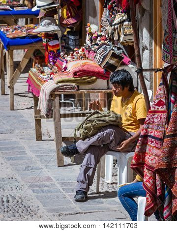 Man Selling Peruvian Bags And Other Souvenirs