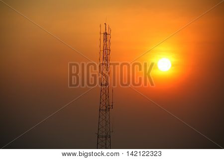 The silhouette or shadow of the attenna with bright sunset