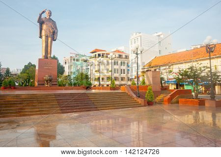 Can Tho, Vietnam - October 16, 2013: Statue remembering Ho Chi Minh saluting mounbted on high plinth overlooking marble clad plza on bank of Mekong River