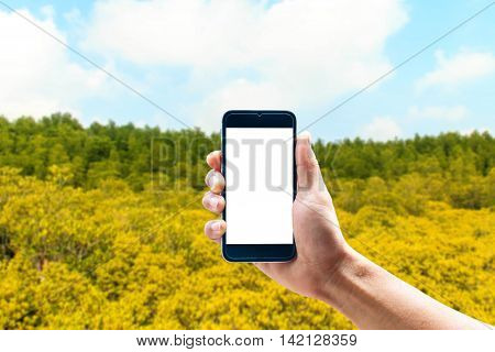 Hand using smartphone mobile in the vertical position, background blur of Beautiful landscapes
