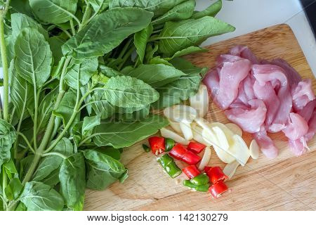 Prepared uncooked ingredient of Thai stir fried pork and basil together with chili and garlic