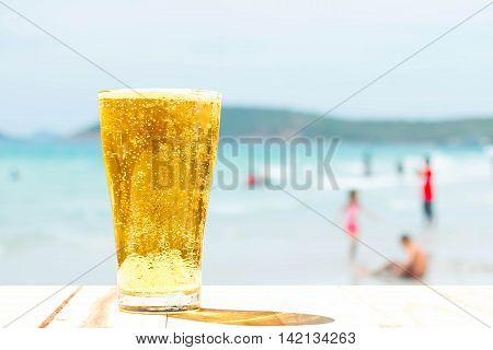 Beer glass on a blurred background of the sea.
