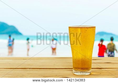 Beer glass on a blurred background of the sea.