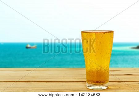 Beer glass on a blurred background of the sea.