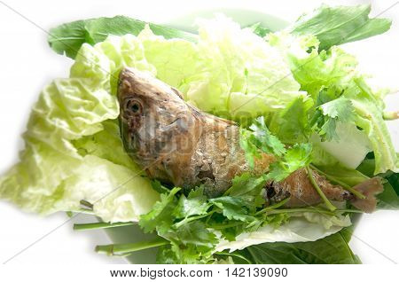 fried mackerel and vegetable Thai food on white