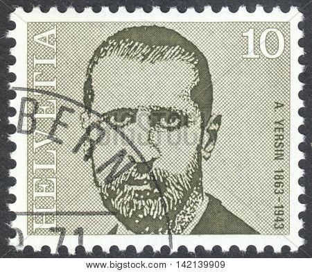 MOSCOW RUSSIA - CIRCA APRIL 2016: a post stamp printed in SWITZERLAND shows a portrait of Alexandre Yersin the series "Doctors" circa 1971