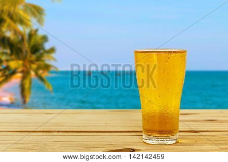 Beer glass on a blurred background of the sea.
