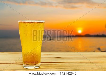 Beer glass on a blurred background of the sea.