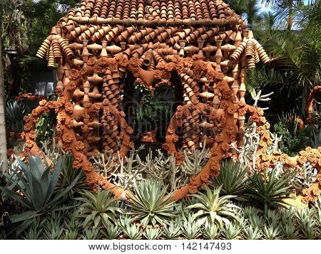 Heart made of mud pots displayed in a garden