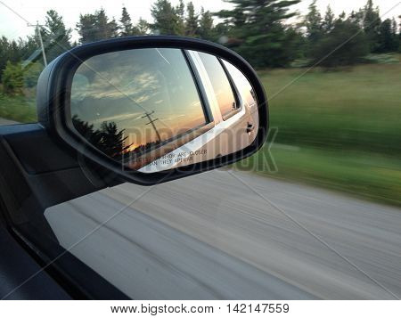 View of the sunset from the rear view mirror