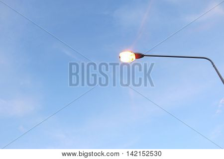 light pole under the blue sky .