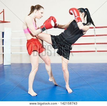 Muay thai woman fighting at boxing ring