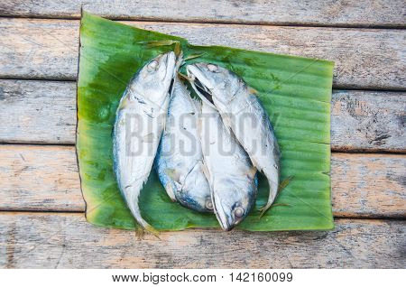 Fresh mackerel or tuna steamed fish on banana green leaf