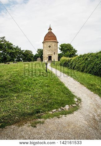 Romanesque rotunda with footpath in Skalica Slovak republic. Architectural theme. Cultural heritage. Travel destination. Vertical composition.