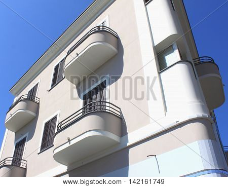 fragment of modern architecture with balconies against the blue sky