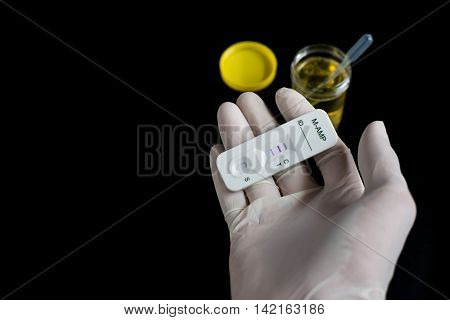 Drug detection of amphetamines in urine on black background
