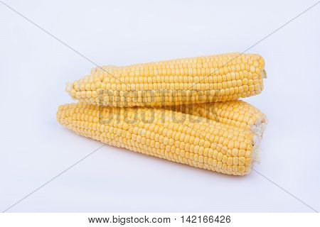 Fresh ripe corn cobs on white background