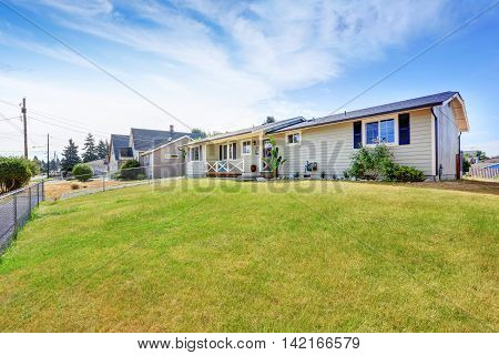American Rambler Exterior With Grass Filled Garden.