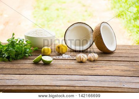 Raw material for food and dessert.Lemon and coconut  and Sticky rice  and coriander on old wooden background outdoor.Raw material Asia food.Raw material Indian food1