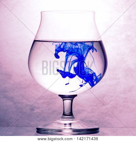 Congac glass with water and ink drops