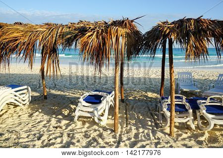 Wonderful tropical beach in Cuba with crystal clear water sunshine and palm leaf sun Umbrellas