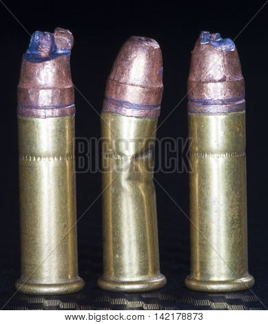 Three rimfire rounds that have been damaged and are unusable