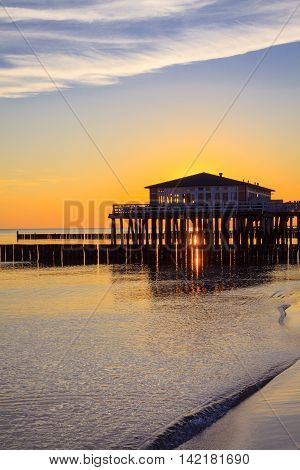 Restaurant at wooden pier on the baltic sea during sunrise. Ustronie Morskie Poland.