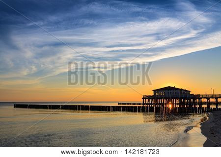 Restaurant at wooden pier on the baltic sea during sunrise. Ustronie Morskie Poland.