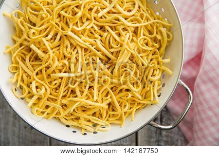 Tasty spaetzle pasta in colander.