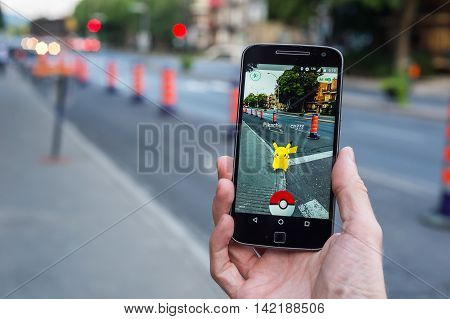 Montreal, Ca - August 10, 2016: Closeup Of A Man Playing Pokemon Go On A Smart Phone. Pokemon Go Is