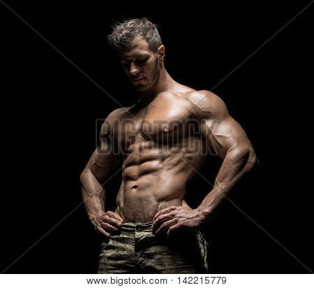 Muscular Athlete Bodybuilder Man On A Dark Background
